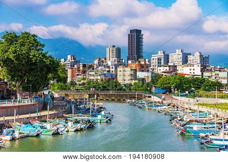 TAIPEI TAIWAN - MAY 29: This is view of Chung Kang fishing port and city buildings in the Guandu area on the outskirts of Taipei on May 29 2017 in Taipei