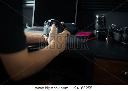 Photographer working checking camera Stylish home studio concept of hipster . Seleted focus.
