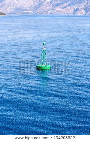 Green buoy floating in sea. Corfu island, Greece