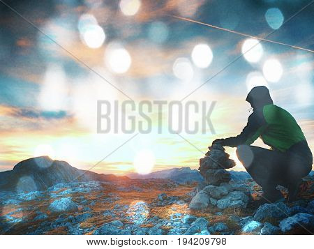 Film Grain Effect.  Alone Adult Man Is Stocking Stone To Pyramid. Alps Mountain Summit,