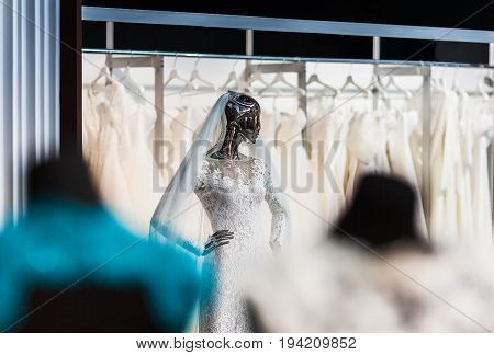 The mannequin looking as liquid terminator in a beautiful wedding attire of the bride shining the polished metal.