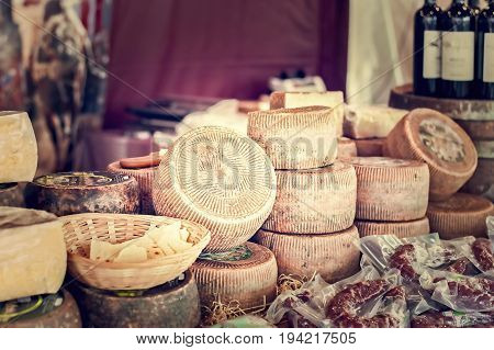 Cheeses And Cut Pieces On Sale At Market.