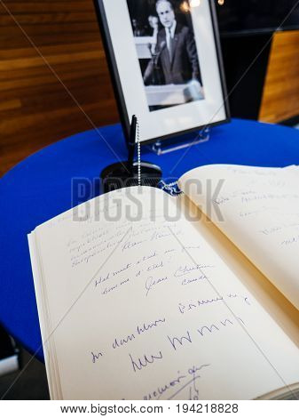 STRASBOURG FRANCE - JUL 1 2017: The messages in diverse languages of high ranked officials on the book of condolences next to a portrait of late former German Chancellor Helmut Kohl at European Parliament. Kohl who was Christ democrat or CDU party member