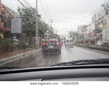Road View Through Car Windshield With Rain Drops, Driving In Rain.