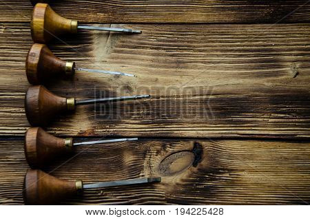 Different Gravers For Jewelry On Wooden Background