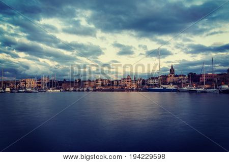 Alghero seen from the sea in vintage tone. Sardinia Italy