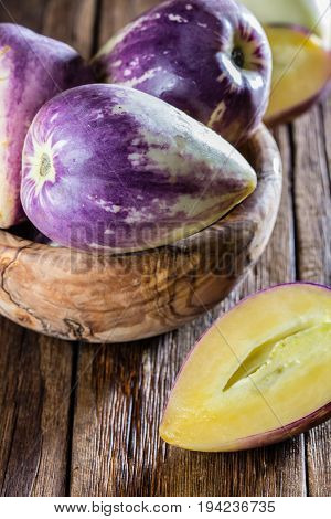 South American fruit sweet cucumber. Pepino dulce or pepino melon on wooden background