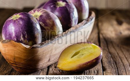 South American fruit sweet cucumber. Pepino dulce or pepino melon on wooden background