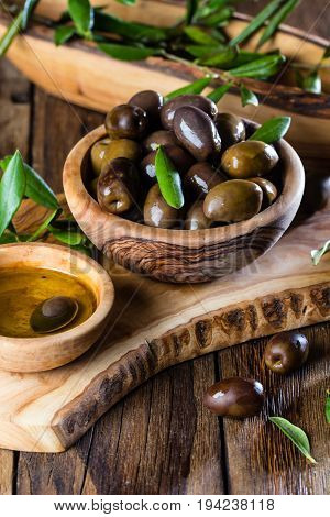 Olives And Olive Oil In Olive Wooden Bowls, Olive Tree Branch