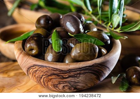 Olives And Olive Oil In Olive Wooden Bowls, Olive Tree Branch