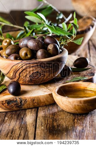 Olives And Olive Oil In Olive Wooden Bowls, Olive Tree Branch