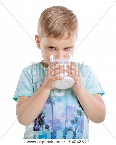 Close-up pretty little boy is drinking milk shake. Charming kid is drinking organic milk isolated on a white background. Adorable small boy is drinking fresh milk.