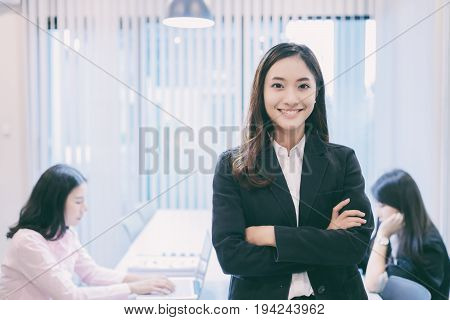 Asian business women and group using notebook for meeting and business women smiling happy for working