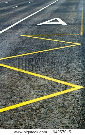Dedicated lanes for public transport on the carriageway with bus stop marking. Focused on letter A.