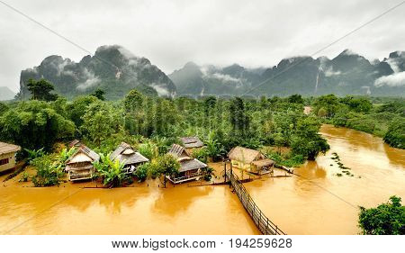 floating river in vangvieng lao after raining day at the morning time with the mist on the hill