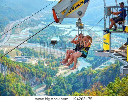 SOCHI, RUSSIA, SEP, 05, 2015: SKYPARK MegaTroll tower start point. Three  people are ready to run RTR. Free fall sliding people tourists for fun. Sochi sightseeing holiday vacation best tours travel