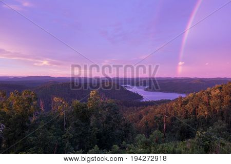 A Brilliant Rainbow at Sunset over Mountain Lake in Broken Bow Oklahoma