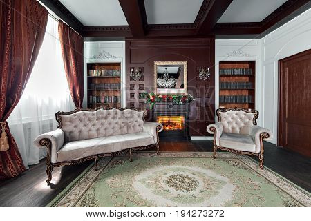 Luxury interior of home library. Sitting room with elegant furniture. shelves with books
