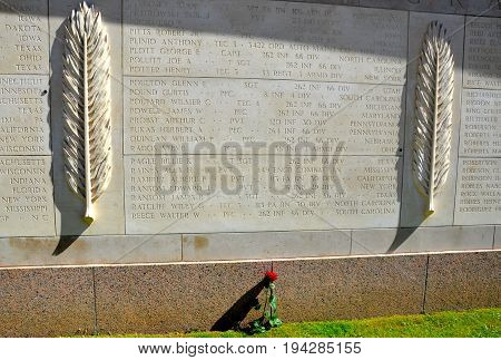 COLLEVILLE-SUR-MER FRANCE - AUG 12: A flower is left at the Normandy American Cemetery and Memorial in Colleville-Sur-Mer France on August 12 2016.