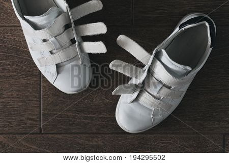 Pair of white shoes on velcro top view close-up