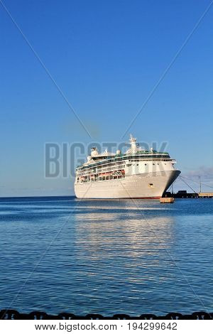 Cruise ship docked on a beautiful blue ocean