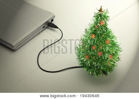 Vacanze di Natale. Albero di Natale USB collegato ad un computer portatile in un ufficio vuoto. Natale foto e
