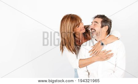 Senior couple posing happily in a photo studio