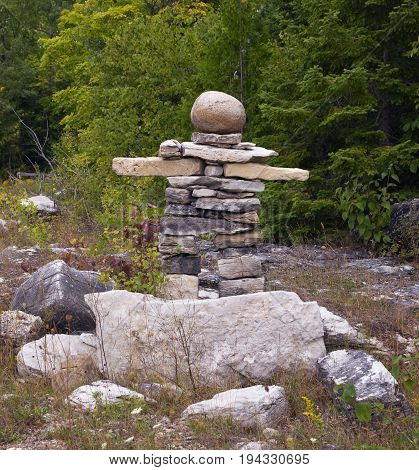 Canadian symbol Inukshuk made from stones near the road