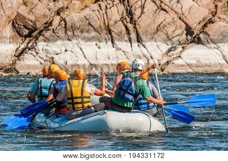 Rafting along the rough river rapids. Extreme vacation in nature