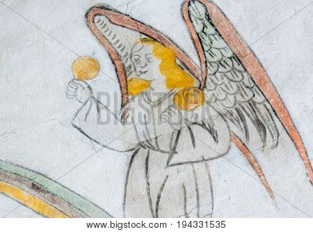 Angel playing maracas medieval gothic fresco in Vinderslev church Denmark June 22 2017