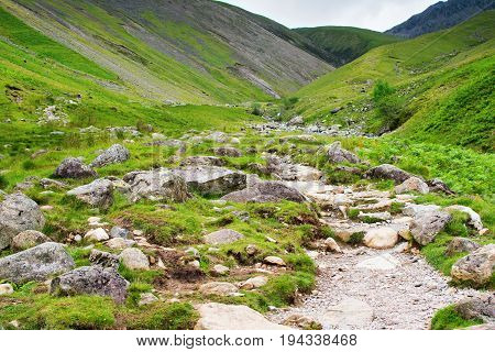 Lake District National Park, path to Scafell Pike, view of the mountains, stream, England, selective focus