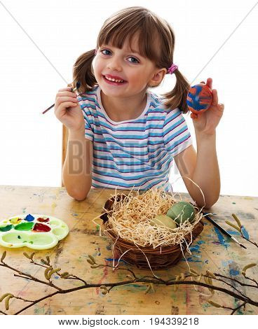 a happy little girl coloring easter eggs