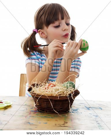 little girl coloring easter eggs white background