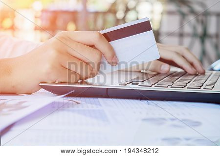 Woman's Hands Holding A Credit Card And Using Smart Phone For Online Shopping.vintage Tone