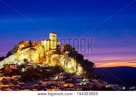 Beautiful sunset in Montefrio and on top of the the rocky outcrop is the Iglesia de la Villa. Granada Spain