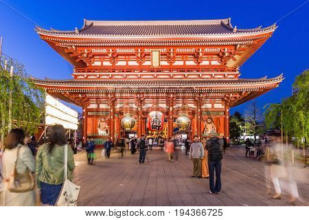 TOKYO, JAPAN - APRIL 12, 2014: Unidentified tourists in the Senso-ji Temple on April 12, 2014 in Tokyo Japan.The Senso-ji Buddhist Temple is the symbol of Asakusa and one of the most famed temples in all of Japan