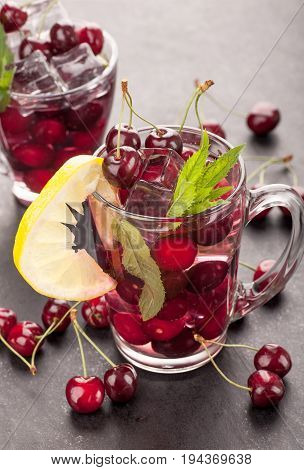 Ice cream and cherry juice on black stone board
