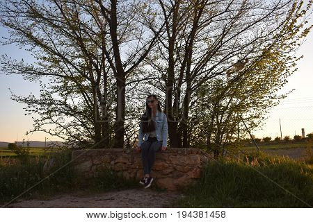 Woman with sunglasses are waiting in the forest