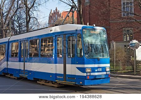 KRAKOW, POLAND - MARCH 28, 2017: Tram MAN N8S-NF in the historic part of Krakow. Total in Krakow more than 90 kilometers of tram tracks and 24 routes.