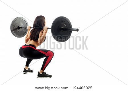 Young sporty woman fitness model brunette doing a seated pad with a barbell on white isolated background standing full squat