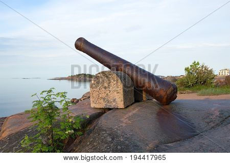 An old cannon on the rocks of the Hanko peninsula in the early June morning. Finland