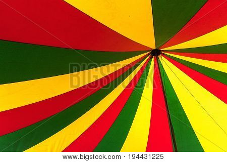 Circus tent in green yellow and red view from below in the top abstract colorful background