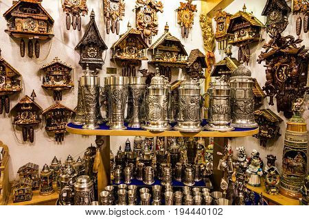 Munich, Germany - July 9, 2017: Beer cups and cuckoo clocks in a souvenir shop in Munich, Bavaria, Germany