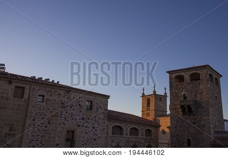 Historic building towers at sunset. Illuminated by last ray of sun Caceres Spain