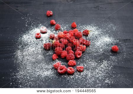 Ripe and tasty raspberries on a wooden background. Raspberries on wooden table .Fresh , vitamins healthy food vegan ingredients.