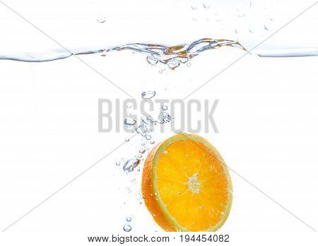orange slice in water splash on white  background