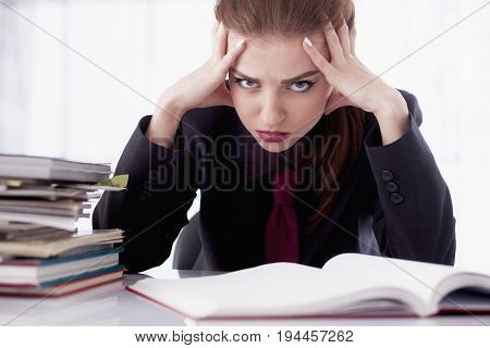 I hate my office work. Office hell. Woman going crazy with work with documents. Low wages overtime working hours lack of career prospects concept. (Body language gestures psychology)