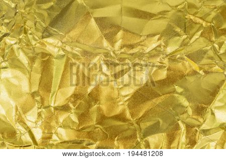 Gold paper texture or Shiny yellow leaf gold foil texture background