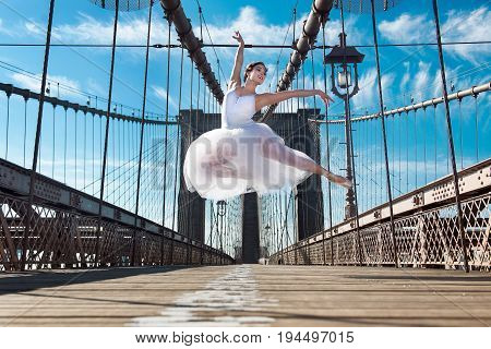 Elegant ballet dancer woman dancing ballet in the city