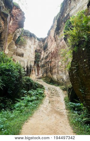 The exploitation of limestone hills canyon forming a unique architectural in Arosbaya Hill Madura Island, Indonesia